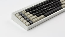 Load image into Gallery viewer, DMK Rubber on silver keyboard angled