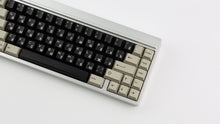 Load image into Gallery viewer, DMK Rubber on silver keyboard angled and zoomed in on right side