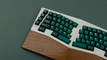 Load image into Gallery viewer, GMK CYL Taiga on a silver keyboard with wrist rest
