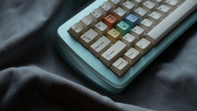 Load image into Gallery viewer, mint green case left side featuring some keycaps