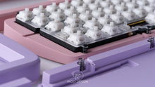 Load image into Gallery viewer, lockup photo featuring both lavender and mist pink case bottoms featuring some keycaps and parts
