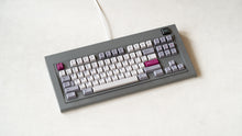 Load image into Gallery viewer, Industrial grey Model OLED at an angle featuring white light purple, and magenta keycaps