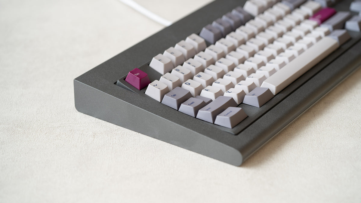  Industrial grey Model OLED zoomed in on left featuring white light purple, and magenta keycaps 