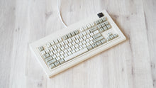 Load image into Gallery viewer, Vintage beige Model OLED at an angle featuring beige and white keycaps with black lettering