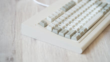 Load image into Gallery viewer, Vintage beige Model OLED zoomed in on left featuring beige and white keycaps with black lettering