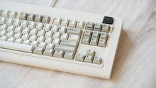 Load image into Gallery viewer, Vintage beige Model OLED zoomed in on right featuring beige and white keycaps with black lettering