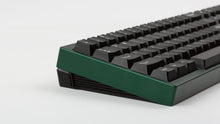 Load image into Gallery viewer, green case featuring white on black keycaps left side