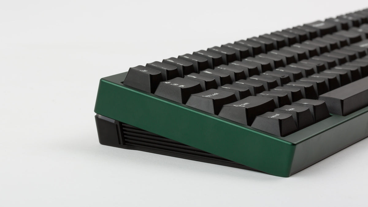 green case featuring white on black keycaps left side