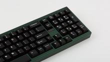 Load image into Gallery viewer, green case featuring white on black keycaps zoomed in on right