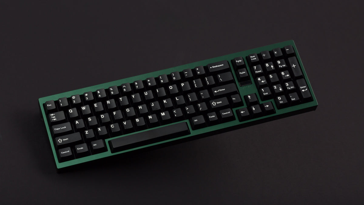 green case featuring white on black keycaps angled