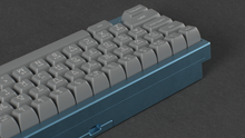 Load image into Gallery viewer, render of SA ASCII on a blue SeisCero keyboard back view left side