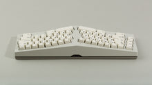 Load image into Gallery viewer, Powder coat beige Type-K back view with sandblasted stainless steel weight featuring black on beige keycaps