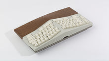Load image into Gallery viewer, Powder coat beige Type-K angled view  with black walnut wrist rest featuring black on beige keycaps