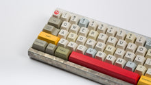 Load image into Gallery viewer, X Wing keycaps on an unfinished Aluminum keyboard zoomed in on left