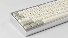 Load image into Gallery viewer, MTNU Beige on silver Keycult No. 2 zoomed in on left