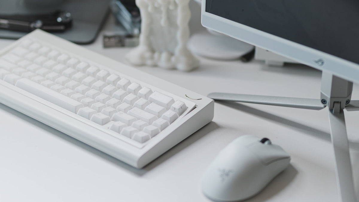  curve 65 keyboard in white on desk right side angled 