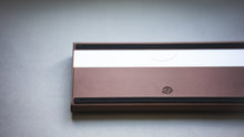 Load image into Gallery viewer, curve 65 keyboard in brown close up on left side bottom view