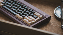 Load image into Gallery viewer, curve 65 keyboard in brown on cork close up on rigt side angled