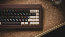 Load image into Gallery viewer, curve 65 keyboard in brown on cork top down close up on right side