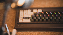 Load image into Gallery viewer, curve 65 keyboard in brown on cork back view close up on right side