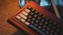Load image into Gallery viewer, curve 65 keyboard in red on cork close up on left side angled