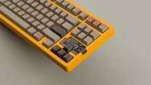 Load image into Gallery viewer, Sunflower yellow MATRIX 8XV 3 ⅓ at an angle featuring grayish brown keycaps with red lettering