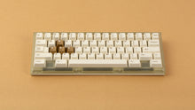Load image into Gallery viewer, Beetle 60 in beige with keycaps and a brown. background