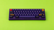 Load image into Gallery viewer, Beetle 60 in purple with keycaps on a green background