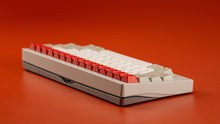 Load image into Gallery viewer, Keyboard with red and white keys on a red background