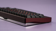 Load image into Gallery viewer, Close-up of a mechanical keyboard with red accents on a purple background