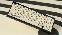 Load image into Gallery viewer, render of GMK CYL Creme on a black keyboard angled