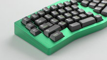 Load image into Gallery viewer, render of GMK CYL Griseann R2 on a green TGR Alice close up on the left side