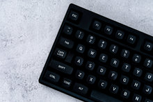 Load image into Gallery viewer, GMK MTNU WoB black keycaps on white keyboard, close-up of right side showing navigation cluster on dark wood