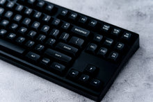Load image into Gallery viewer, GMK MTNU WoB black keycaps on white keyboard, elevated angle showing full layout on dark wood