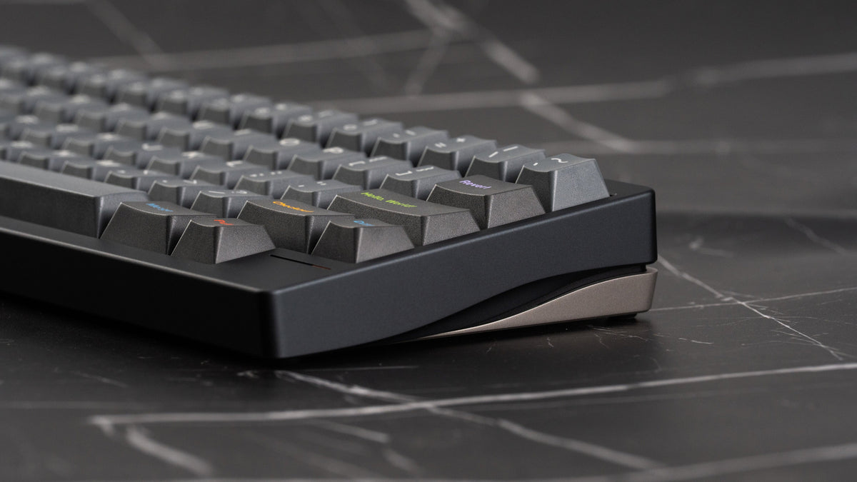 Close-up of a mechanical keyboard on a dark surface with geometric patterns 