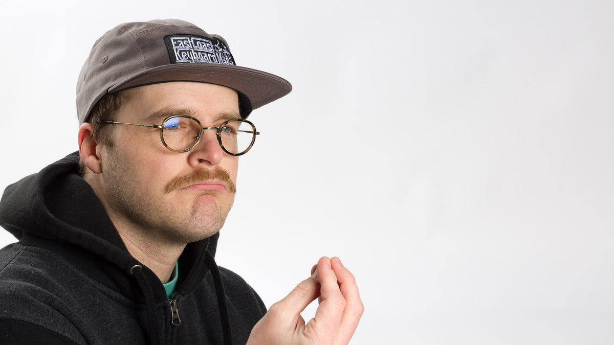  Model contemplating wearing a Grey East Coast Keyboard Mafia hat 