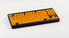 Load image into Gallery viewer, GMK CYL ADA orange keycaps on black TKL keyboard, angled perspective