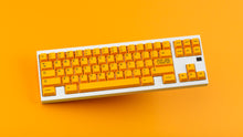 Load image into Gallery viewer, GMK CYL ADA keycaps on white TKL keyboard, angled top-down on orange background