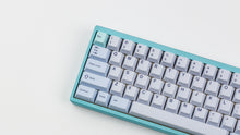 Load image into Gallery viewer, GMK CYL Astral Light on a blue keyboard close up left side angled