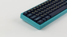 Load image into Gallery viewer, GMK CYL Awaken on a blue keyboard zoomed in on left