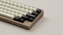 Load image into Gallery viewer, GMK CYL Black Snail on a beige keyboard zoomed in on right