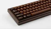 Load image into Gallery viewer, GMK CYL Chocolatier keycaps on dark brown hammered-texture keyboard, close-up of left side