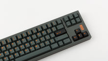Load image into Gallery viewer, GMK CYL Cinder on grey keyboard zoomed in on right angled