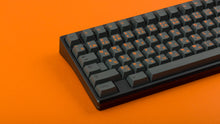 Load image into Gallery viewer, GMK CYL Cinder on black keyboard zoomed in on left