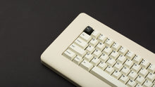 Load image into Gallery viewer, GMK CYL Creme on a beige keyboard close up on left side angled