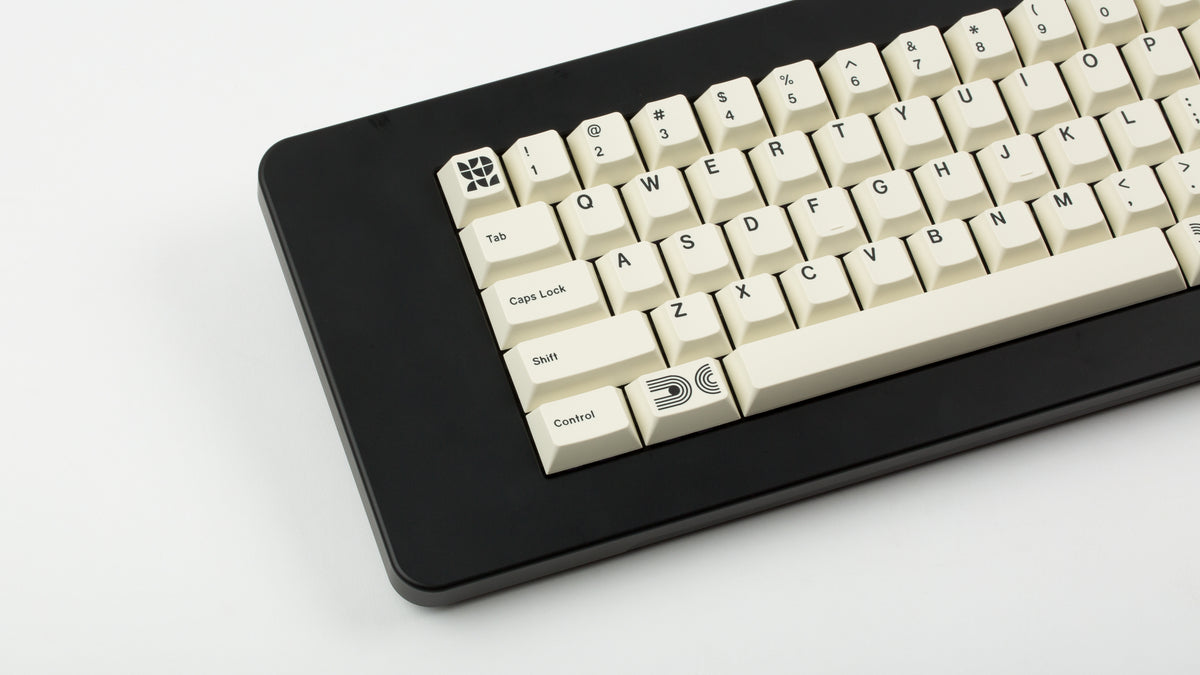  GMK CYL Creme on a black keyboard close up on left side 