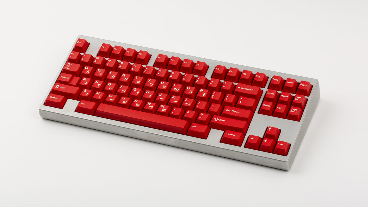  GMK CYL Crimson Cadet on a silver keyboard angled 