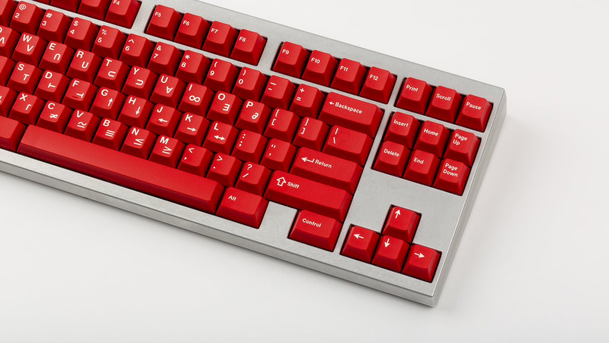  GMK CYL Crimson Cadet on a silver keyboard close up on right side angled 
