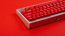 Load image into Gallery viewer, GMK CYL Crimson Cadet on a silver Keycult Zero keyboard with PC accent bars on a red background close up of back right side