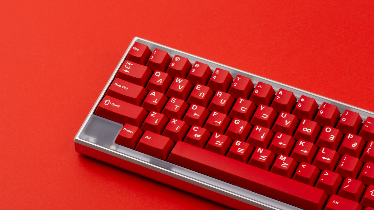  GMK CYL Crimson Cadet on a silver Keycult Zero keyboard with PC accent bars on a red background close up of left side 